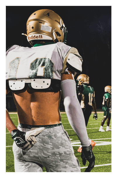 A young man wearing a football jersey with the name Vista on the back. AI generated content