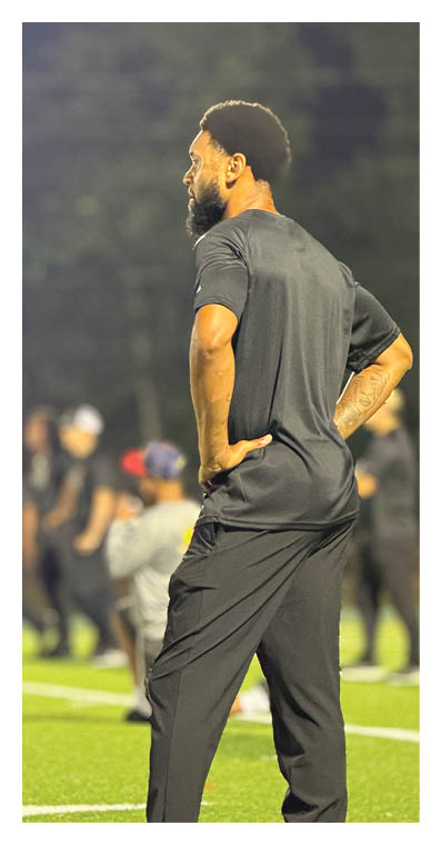 A football player in a white jersey with the number 85 on it is trying to catch a football. AI generated content