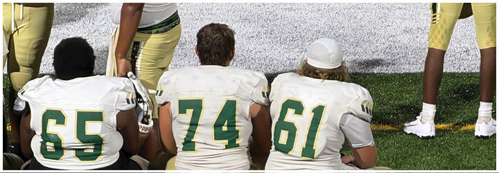 A section of a green artificial turf field with white and yellow painted lines. Description generated by AI