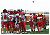A group of football players on a field. Description generated by AI
