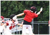 A group of football players on a field. Description generated by AI