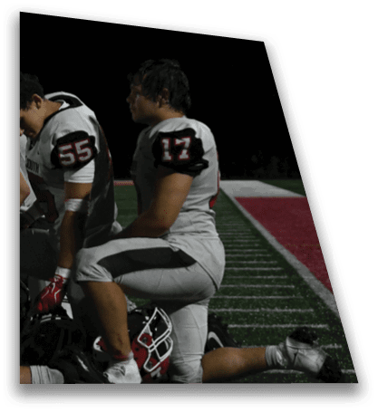 A person wearing a sports jersey with the number 17 is shown in profile against a dark background. Description generated by AI