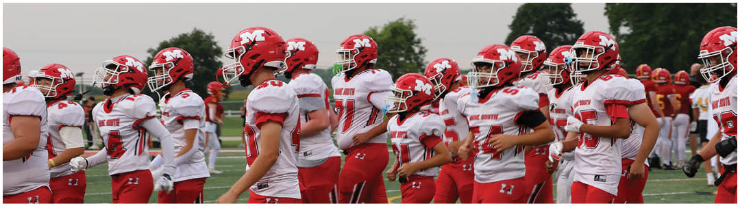 A group of people wearing red and white football uniforms and helmets are standing on a field, appearing to prepare for a game or practice. Description generated by AI