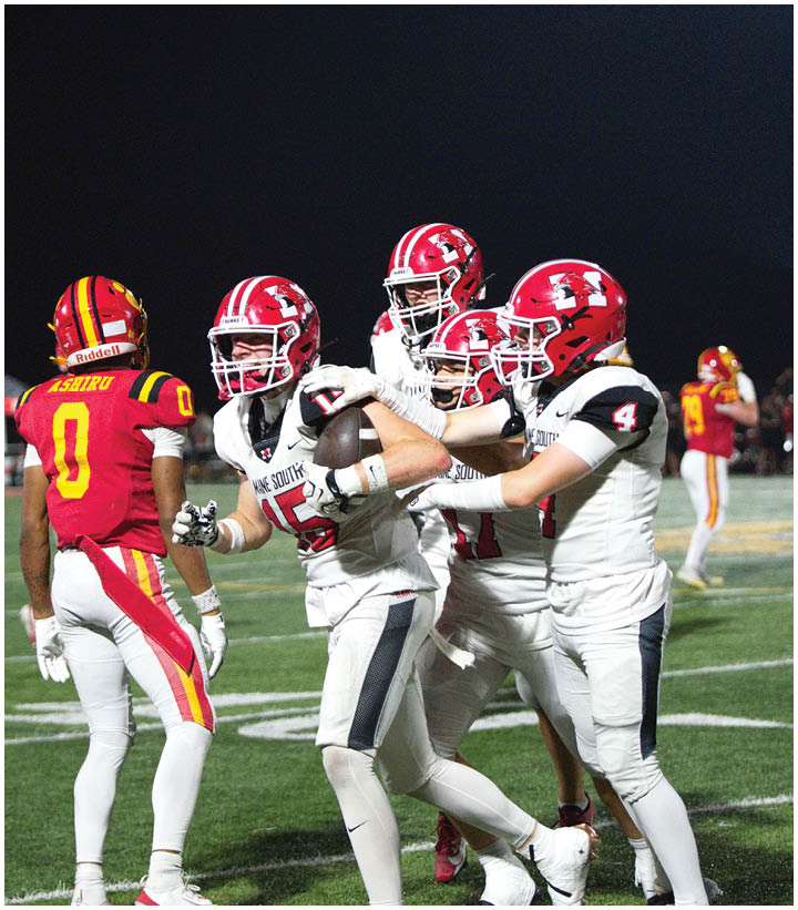 A group of football players wearing black and white uniforms. Description generated by AI
