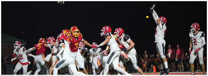 A football player is sliding on the ground. Description generated by AI