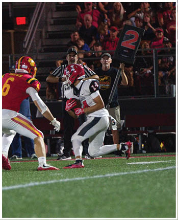 A group of football players celebrating a touchdown. Description generated by AI