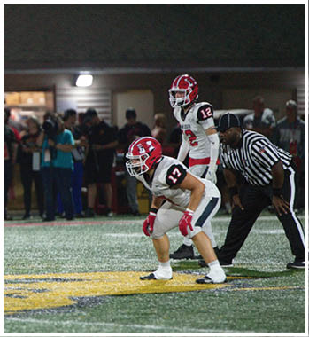 A group of football players celebrating a touchdown. Description generated by AI