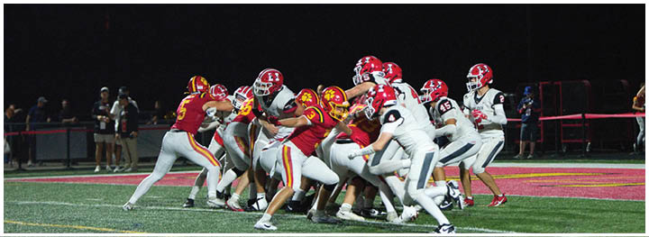 A football player is sliding on the ground. Description generated by AI
