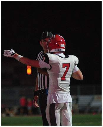 A group of football players celebrating a touchdown. Description generated by AI