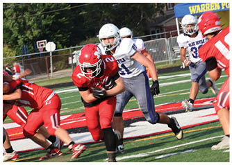 A group of football players on a field. Description generated by AI