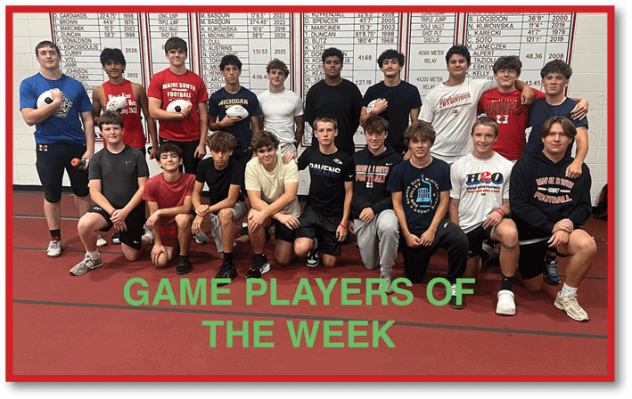 A group of people wearing casual athletic clothing pose together indoors on a gym floor with a scoreboard in the background and the text “GAME PLAYERS OF THE WEEK" overlaid at the bottom. Description generated by AI