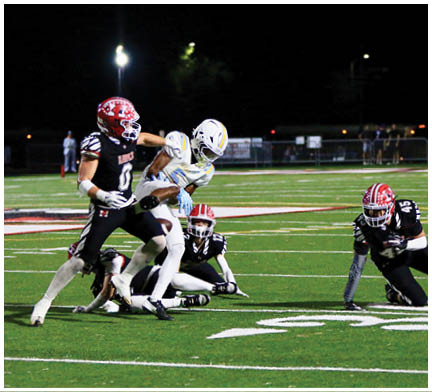 A group of football players on a field. Description generated by AI