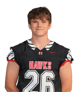 A person wearing a black sports jersey with the word “HAWKS" in red and white letters and a red Nike logo. Description generated by AI