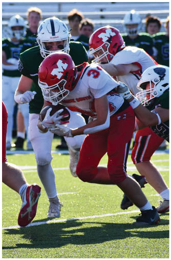 Two people in red and white football uniforms are tackling a person in a green and white uniform on a sunlit football field. Description generated by AI