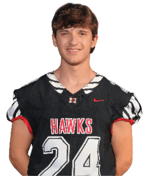 A person wearing a black football uniform with the word “HAWKS" and the number 24 on the front is standing and smiling against a white background. Description generated by AI