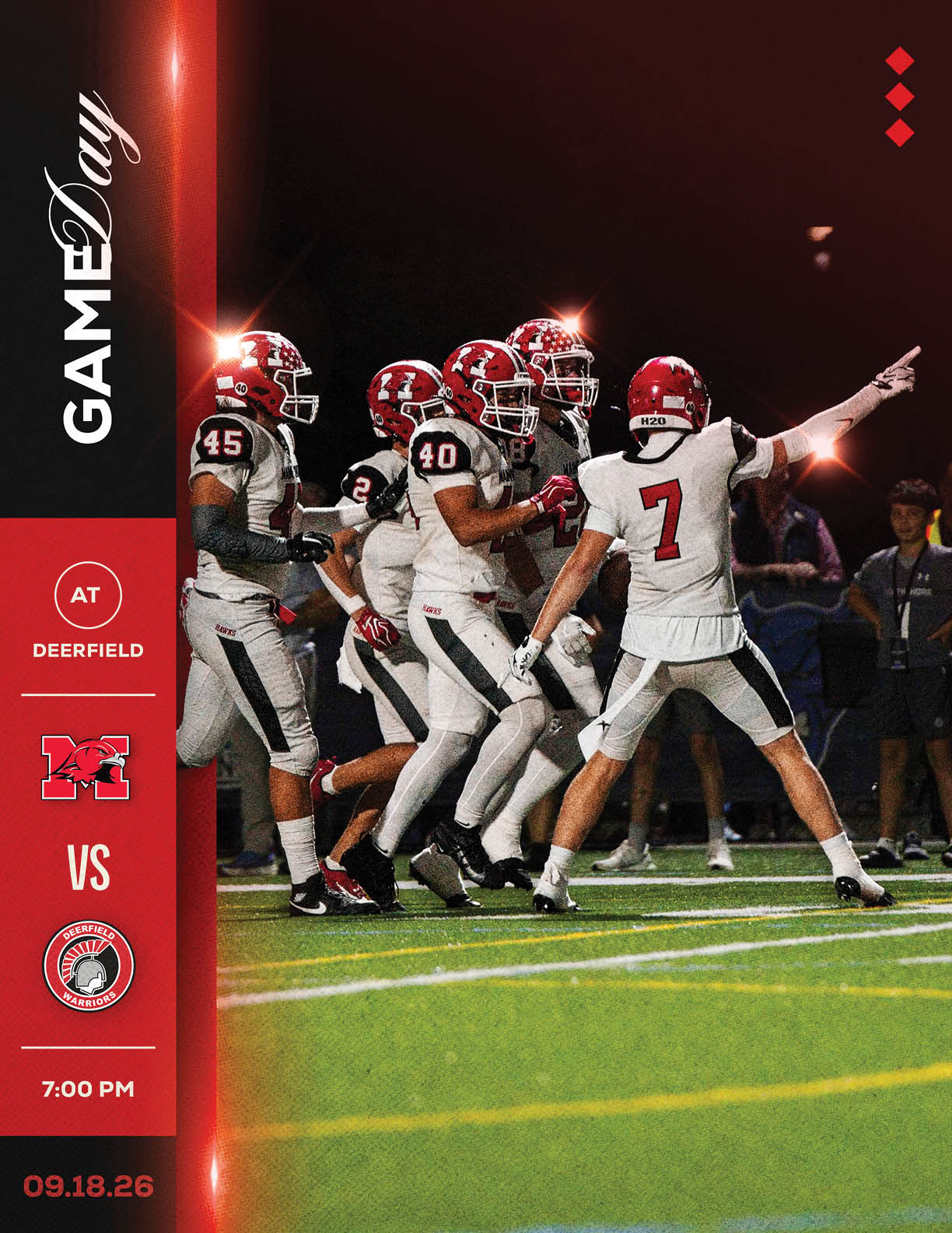 A group of football players in white uniforms with red helmets are celebrating on a field under stadium lights during a night game announcement for a match between two teams at Deerfield. Description generated by AI