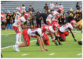A group of football players on a field. Description generated by AI