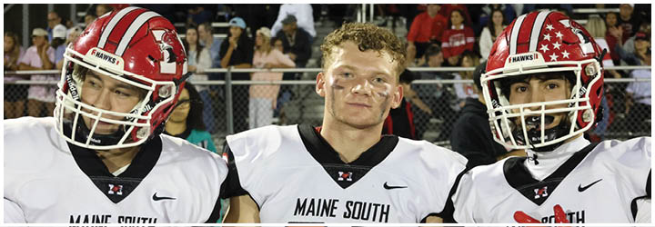 Three people wearing white football jerseys with “Maine South" written on them stand closely together, with one person in the center and two partially visible on either side. Description generated by AI