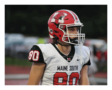 A person wearing a red football helmet and a white jersey with the number 80 and the words Maine South is standing on a field. Description generated by AI