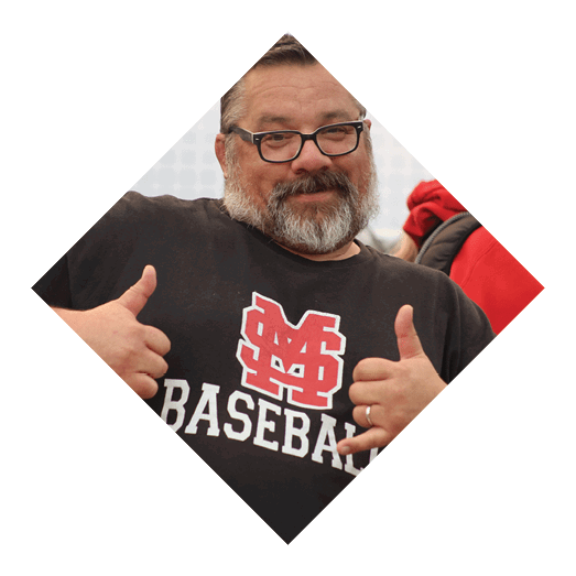 A person wearing a black shirt with a red and white logo and the word “BASEBALL" is making a shaka hand gesture. Description generated by AI