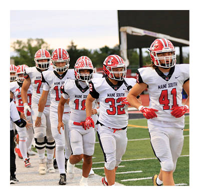 Two people wearing white football uniforms with red helmets and gloves are on a field, one with the number 41 and the other with the number 80. Description generated by AI