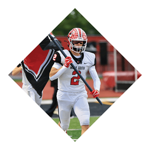 A person wearing a white sports uniform with the number 2 and holding a black flag is running on a field. Description generated by AI