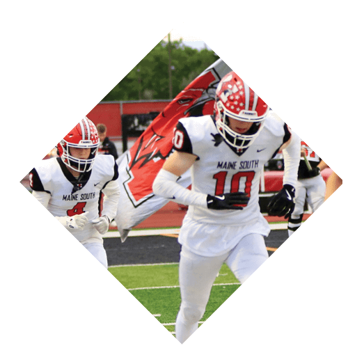A person wearing a white football uniform with “Maine South" on the jersey and a red helmet is running on a field near the sideline. Description generated by AI