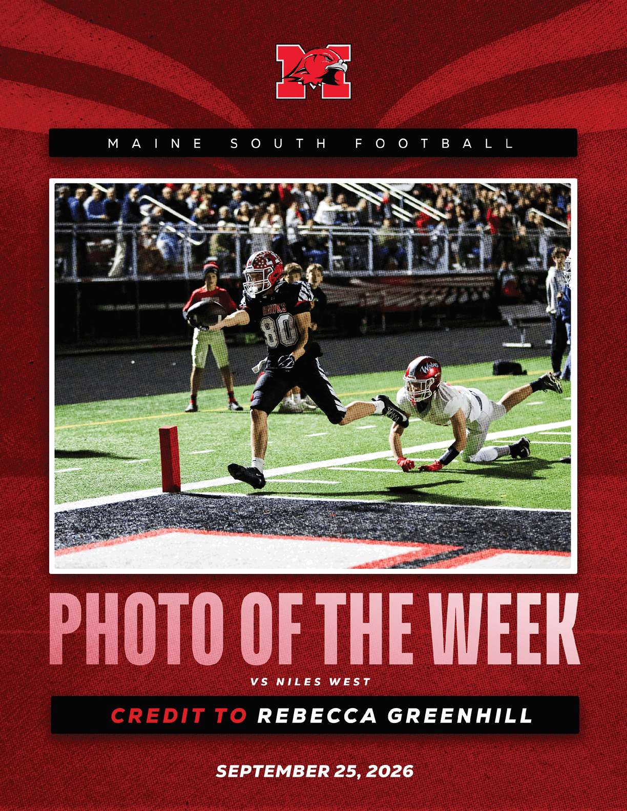 A football player in a dark uniform is running into the end zone while a player in a white uniform dives in an attempt to tackle them during a night game with spectators in the background. Description generated by AI