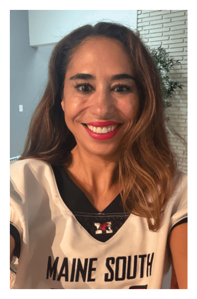 A person with long hair is smiling brightly with visible teeth and wearing bright pink lipstick. Description generated by AI