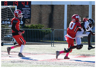 A group of football players on a field. Description generated by AI