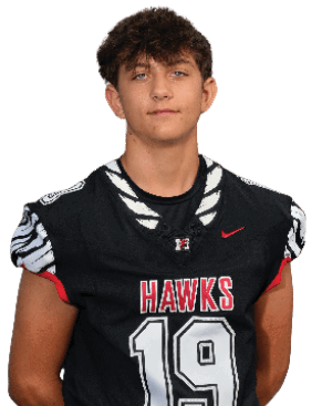 A person with short curly hair is wearing a black sports jersey with the word “HAWKS" and the number 12 on it. Description generated by AI