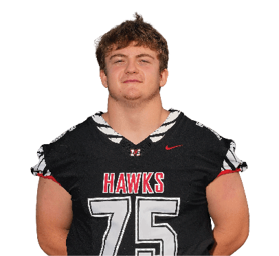A person wearing a black football uniform with the number 75 and the word “HAWKS" on the front stands with hands behind their back. Description generated by AI