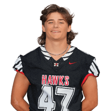 Person wearing a black sports jersey with the word “HAWKS" and the number 47, featuring a red Nike logo and a zebra-striped pattern on the collar and sleeves. Description generated by AI