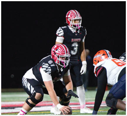 A group of football players on a field. Description generated by AI