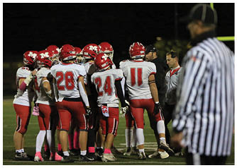 A group of football players on a field. Description generated by AI
