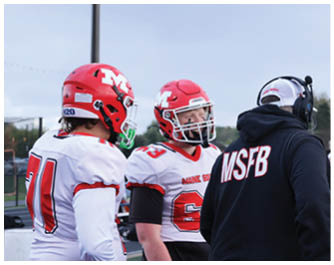 Two people wearing red and white football helmets and jerseys are standing next to a person in a black hoodie with the letters MSFB on the back. Description generated by AI