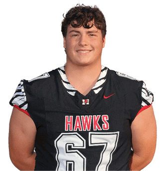 Person with curly hair wearing a black football jersey with the word “HAWKS" and the number 67 smiling with hands behind their back. Description generated by AI