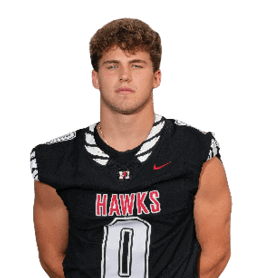 A person with short curly hair wearing a black sports jersey with the word “HAWKS" and the number 8 on it is standing against a white background. Description generated by AI