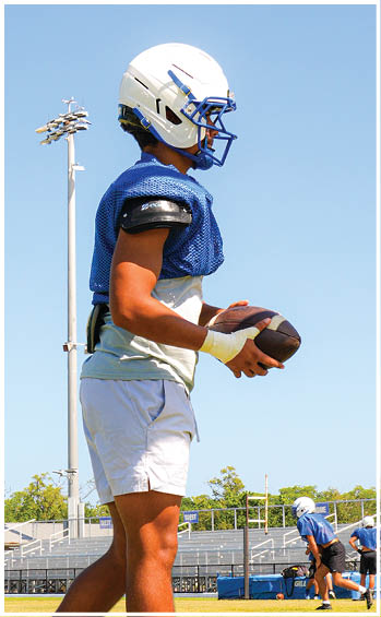 A football player running on the field. Description generated by AI