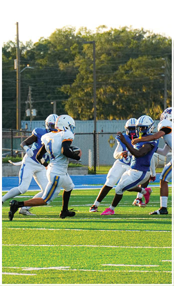 A football player running on the field. Description generated by AI