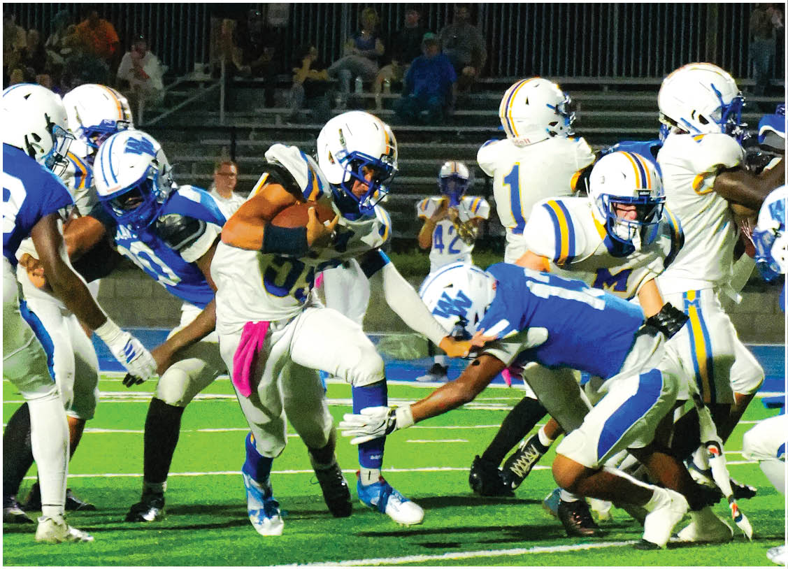 A group of football players wearing black and white uniforms. Description generated by AI