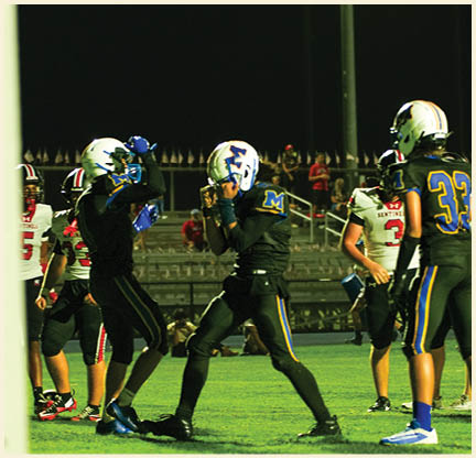 Two football players wearing black jerseys with the number 11 on them. Description generated by AI