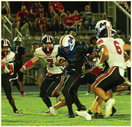 A group of football players posing for a picture. Description generated by AI
