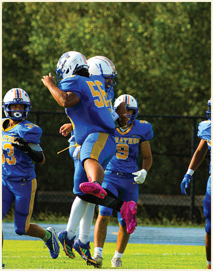A football player wearing a black jersey with the number 11 on it. Description generated by AI