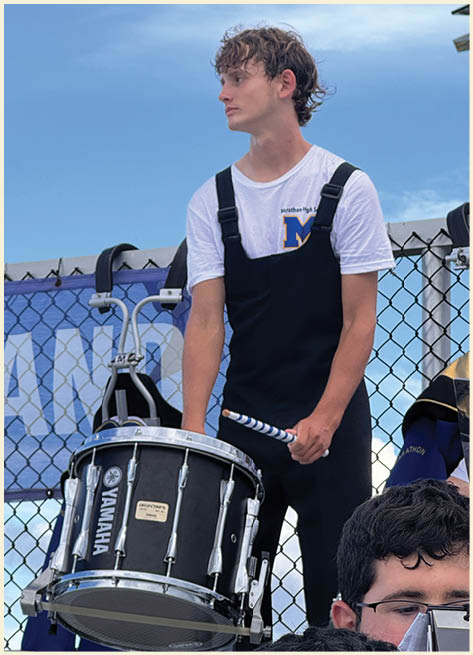A football player wearing a black jersey with the number 11 on it. Description generated by AI