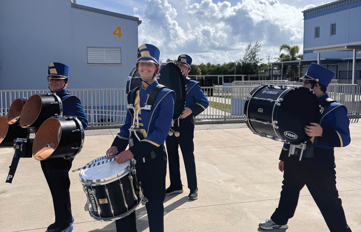 A group of people wearing black and white uniforms. Description generated by AI