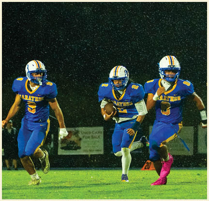 A group of football players posing for a picture. Description generated by AI