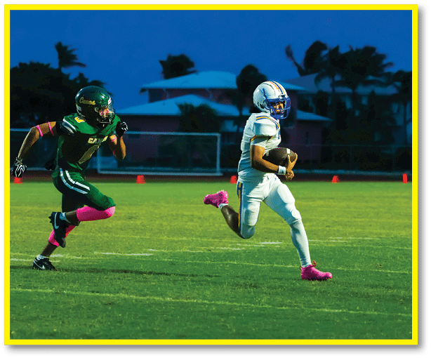 A football player running on the field. Description generated by AI