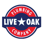 A circular logo with a red outer ring containing the words “PLUMBING" and "COMPANY" and a blue inner band with the words "LIVE OAK" separated by a white star in the center. Description generated by AI