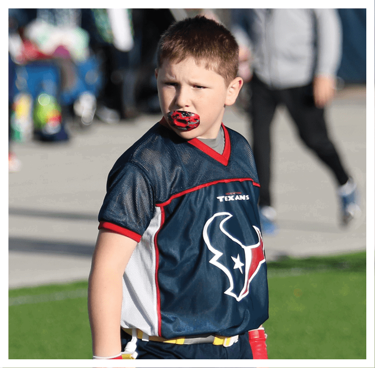 A football player wearing a blue and red jersey. Description generated by AI
